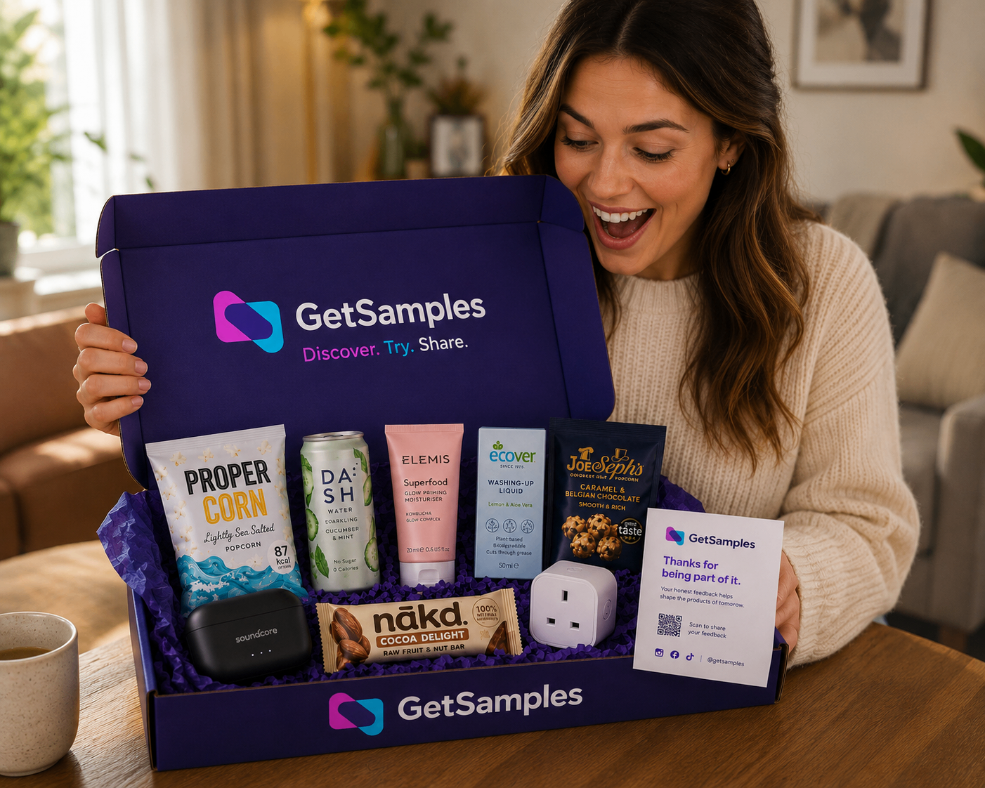 A woman smiling as she opens her GetSamples discovery box on a wooden table at home.